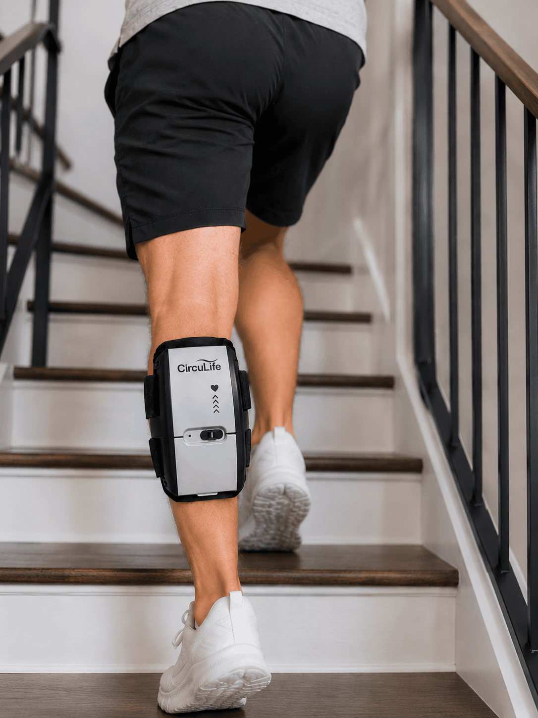 A patient climbing stairs at home wearing the CircuLife active compression device.