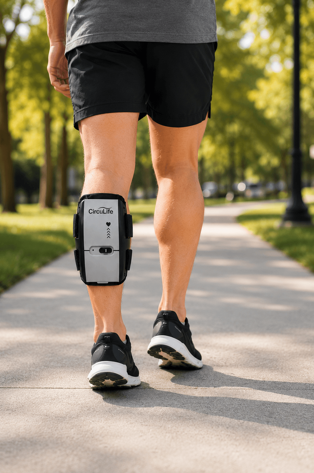 A patient walking outdoors with the CircuLife active compression device on his calf.